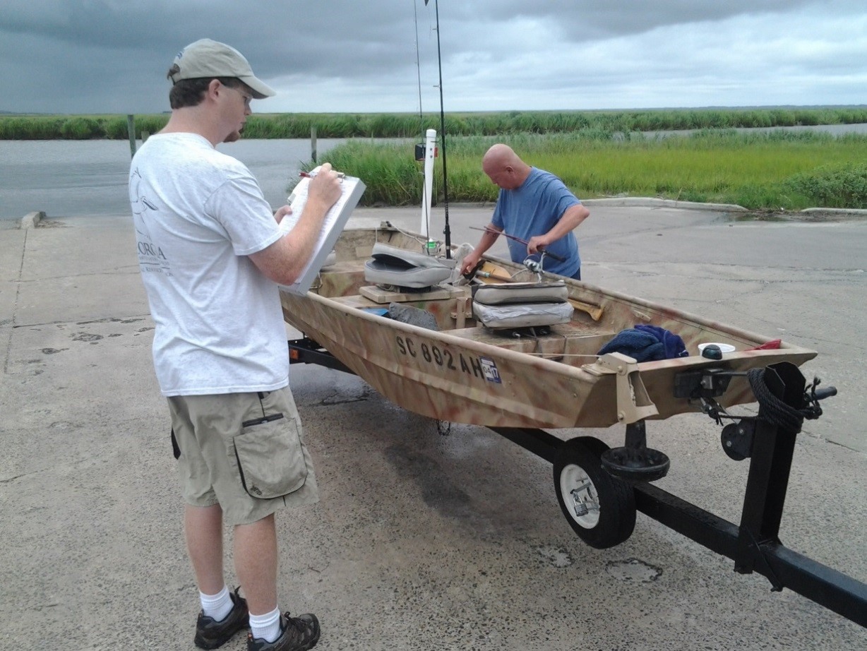 In this photo, a staff member from the Coastal Resources Division of the Georgia Department of Natural Resources interviews an angler as part of the annual Access Point Angler Intercept Survey.