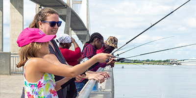 A woman and child fishing (thumbnail for the fishing event article)
