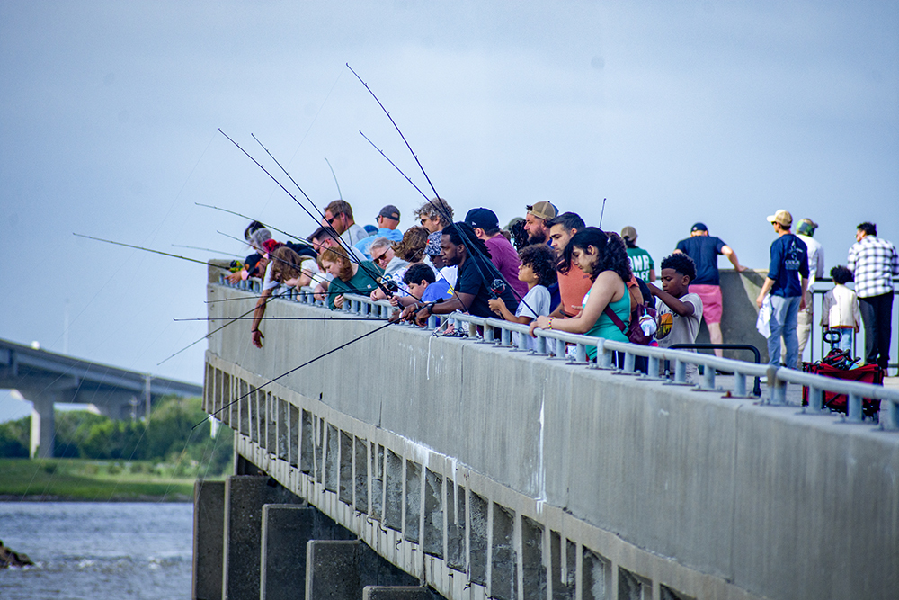Participants at the John Pafford Memorial Kids Fishing Event fishing off of the pier