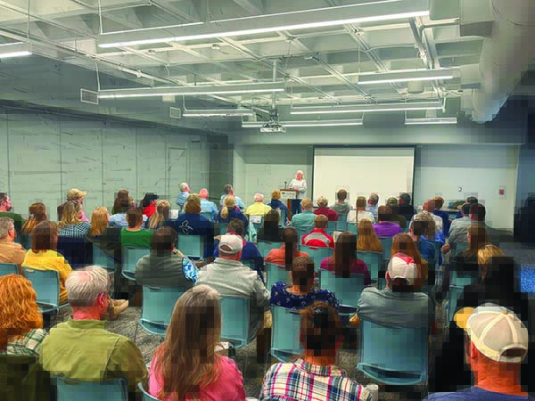 Tyler Jones/CRD Eamonn Leonard, left, a botanist with WRD, poses in front of the Liberty Garden with CRD Director Doug Haymans.