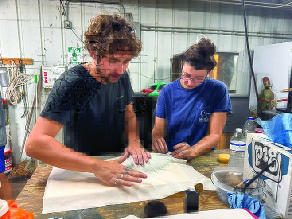 Tyler Jones/CRD photos
Marine biologist Britany Hall, right, helps public affairs assistant Fisher Medders make a gyotaku print on muslin cloth.