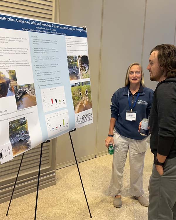Brooke Vallaster/CRD Wetlands technician Alana Johnson, left, shows off her poster dispay during the Georgia Resiliency Conference.