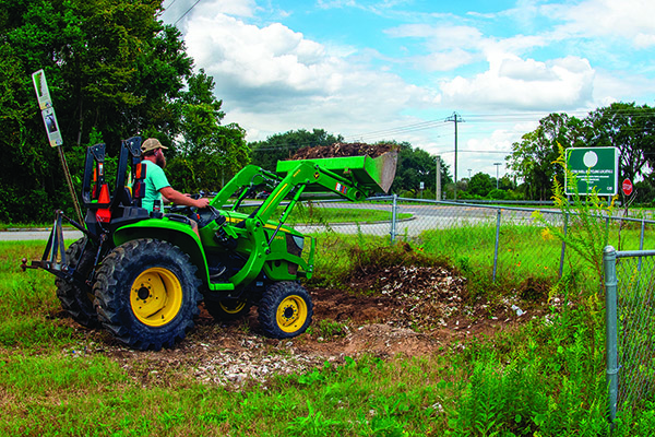 CRD photo Marine biologist Cameron Brinton uses a front-end loader to prepare the Montgomery Cross Road shell recycling station in Savannah for a new collection bin on Oct. 8.