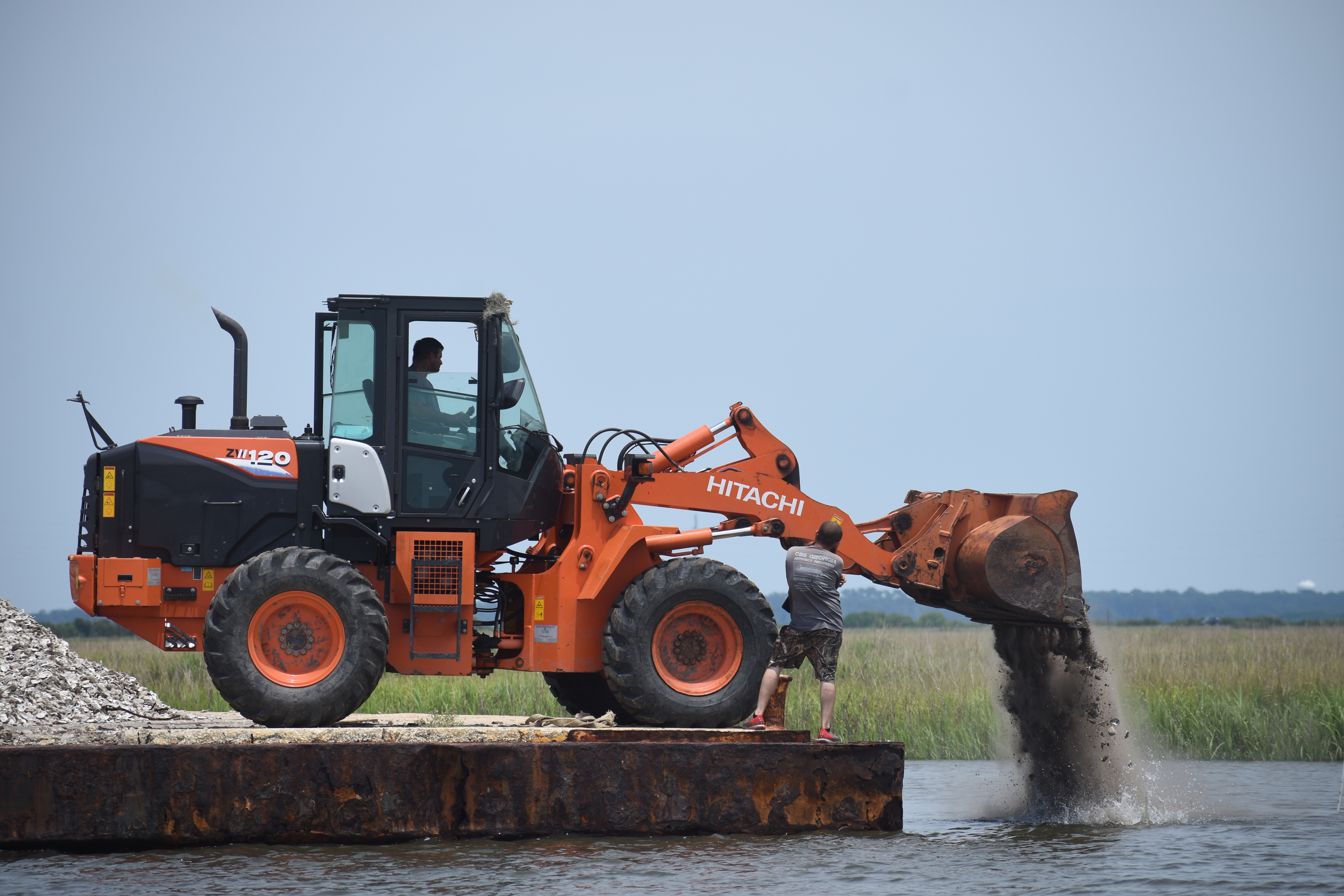 Front loader places oyster shells in Jointer Creek