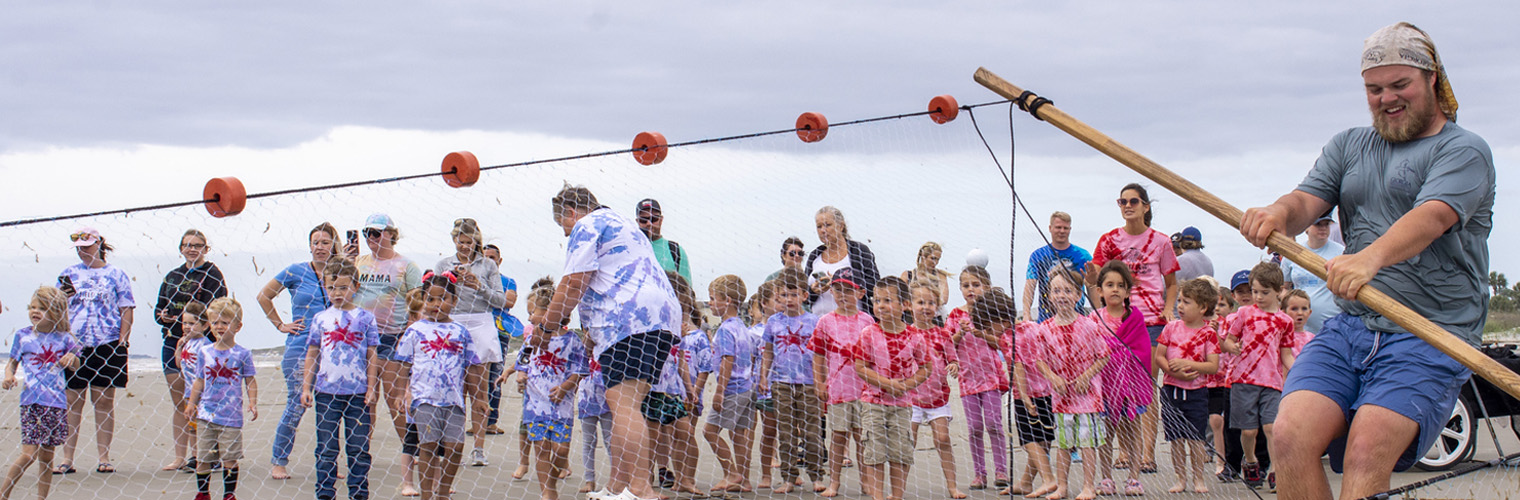 Header Image depicting an employee Seine Netting with a group.