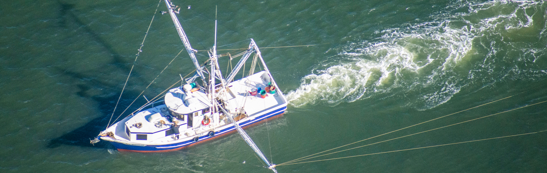 A shrimp boat pulls a trawl net.
