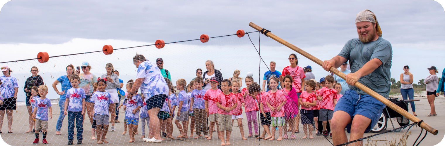 Header Image depicting an employee Seine Netting with a group.