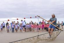 Sean Tarpley pulls a seine net during a demonstration for Pre-K students on April 22, 2022, at Great Dunes beach on Jekyll Island.